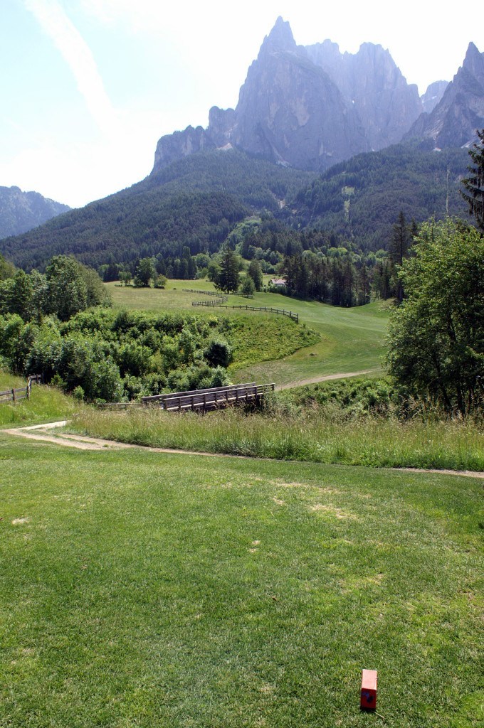 The 5th tee in Kastelruth in the Dolomites, bridge, and fairway