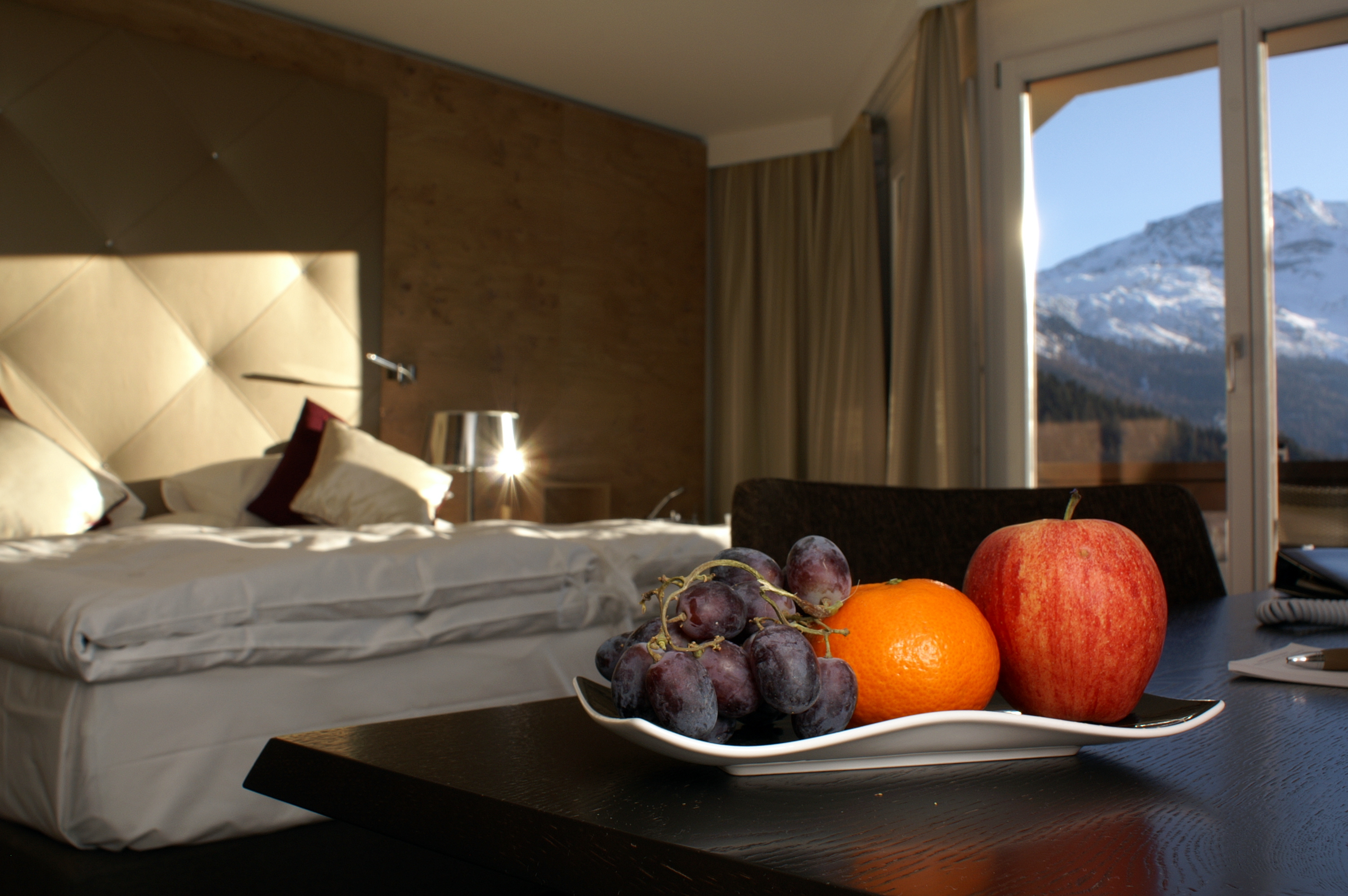 Fruits, view of Swiss Alps and hotel bed in Giardino Mountain resort