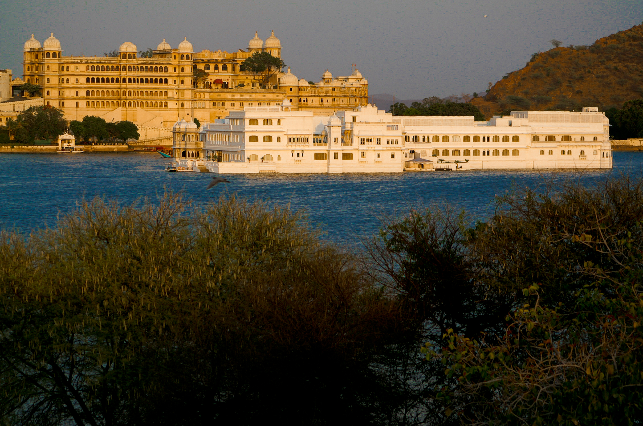 View from Oberoi Udaivilas on Lake Pichola with Lake Palace and Fateh Prakash Palace in Udaipur