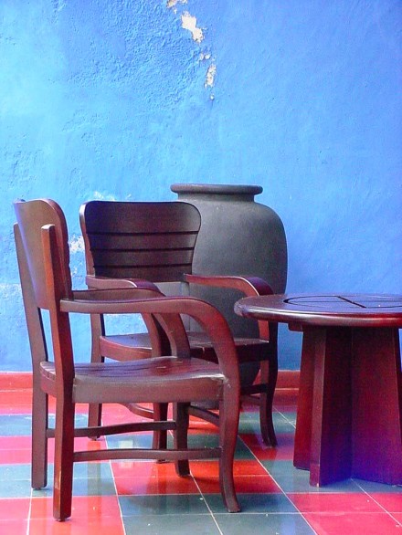 Chairs and vase in front of blue wall in a hacienda in Yucatan, Mexico