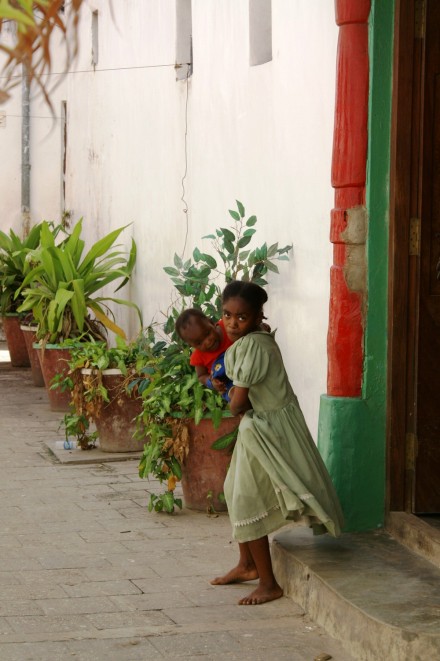 Shy girl hiding away in Zanzibar