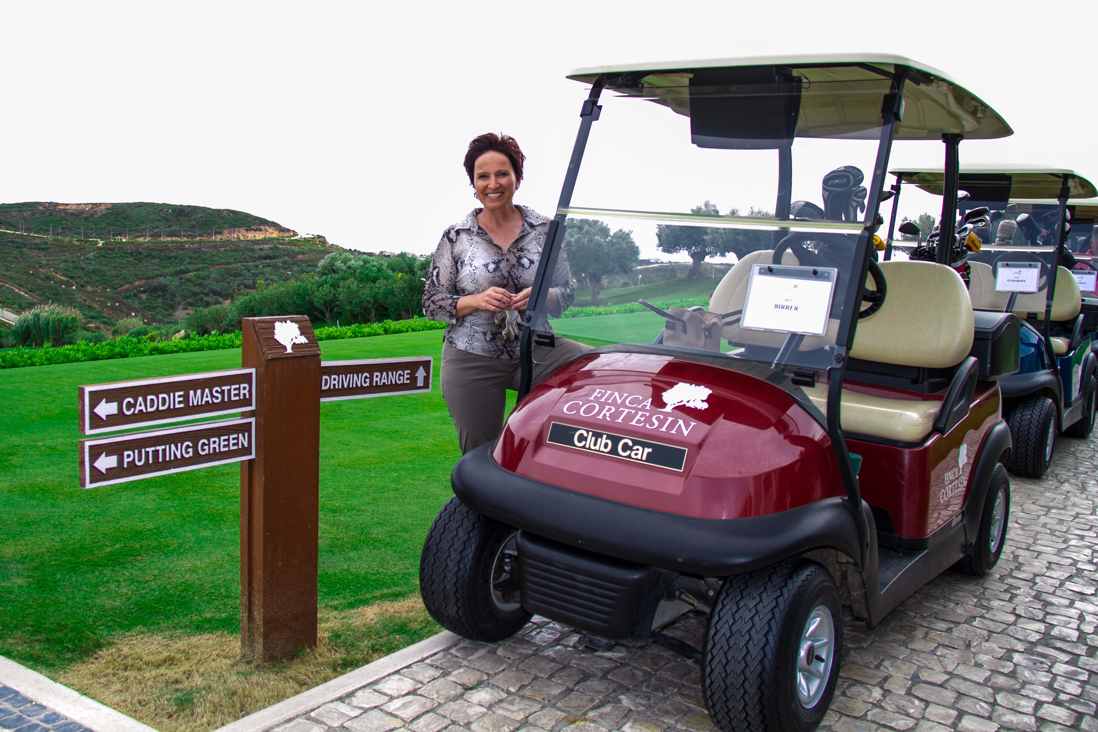 Katja on a golf buggy in Finca Cortesin golf course