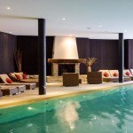 The heated pool and fireplace at the Chalet RoyAlp Hôtel & Spa high in the Swiss Vaud Alps village of Villars-sur-Ollon