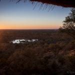 Sonnenuntergang über dem Wasserloch der Victoria Falls Safari Lodge