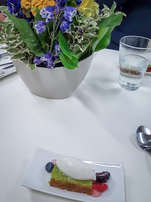 Pistachio cake with yoghurt cream, fresh berries and jelly of roses