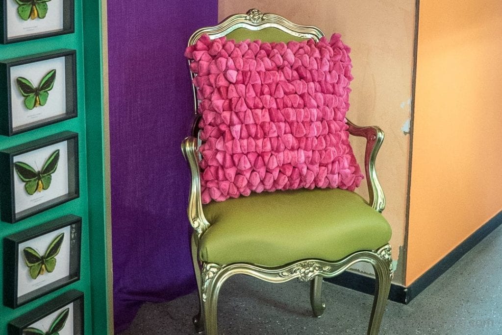 Green chair with pink pillow
