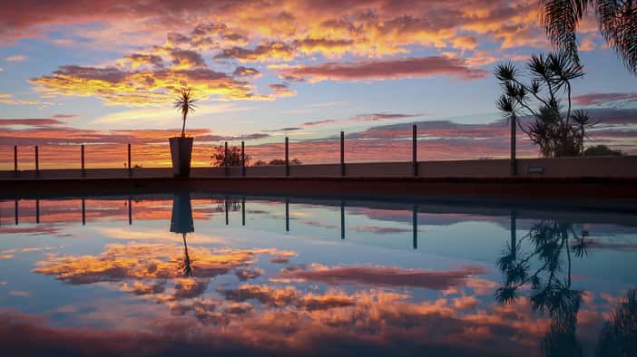 Sunrise over the pool at Wings Hinterland Retreat