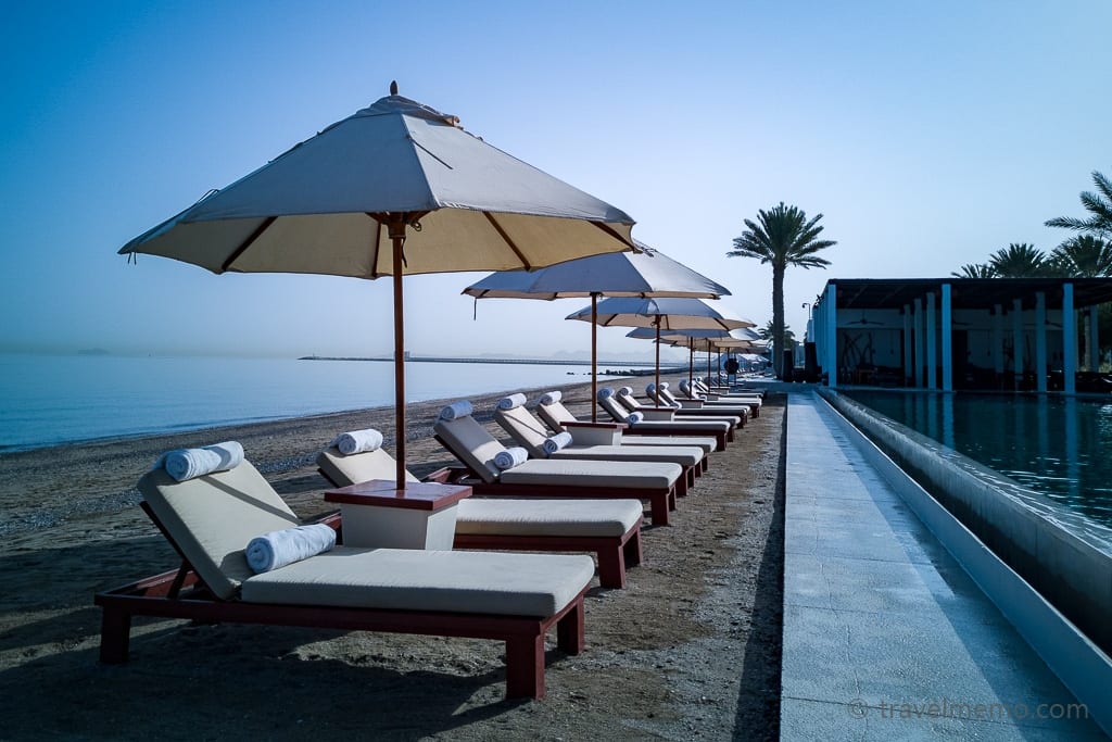 Lounge chairs lined up by the Chedi Pool