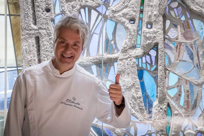 Chef Fernando Canales in front of stained glass