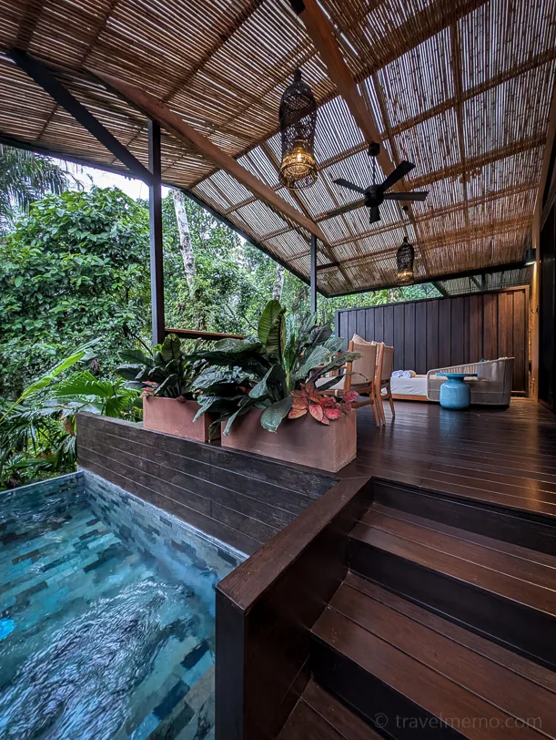 Open villa in the Nayara Garden Hotel with bamboo canopy, teak terrace, small pool and tropical plants in the background